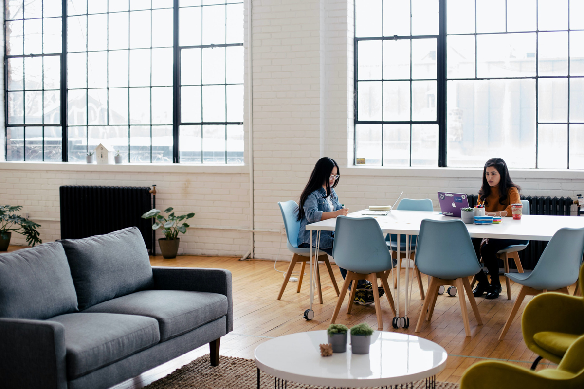 Two people sitting in front of white table - Credit to @youxventures, image supplied via Unsplash