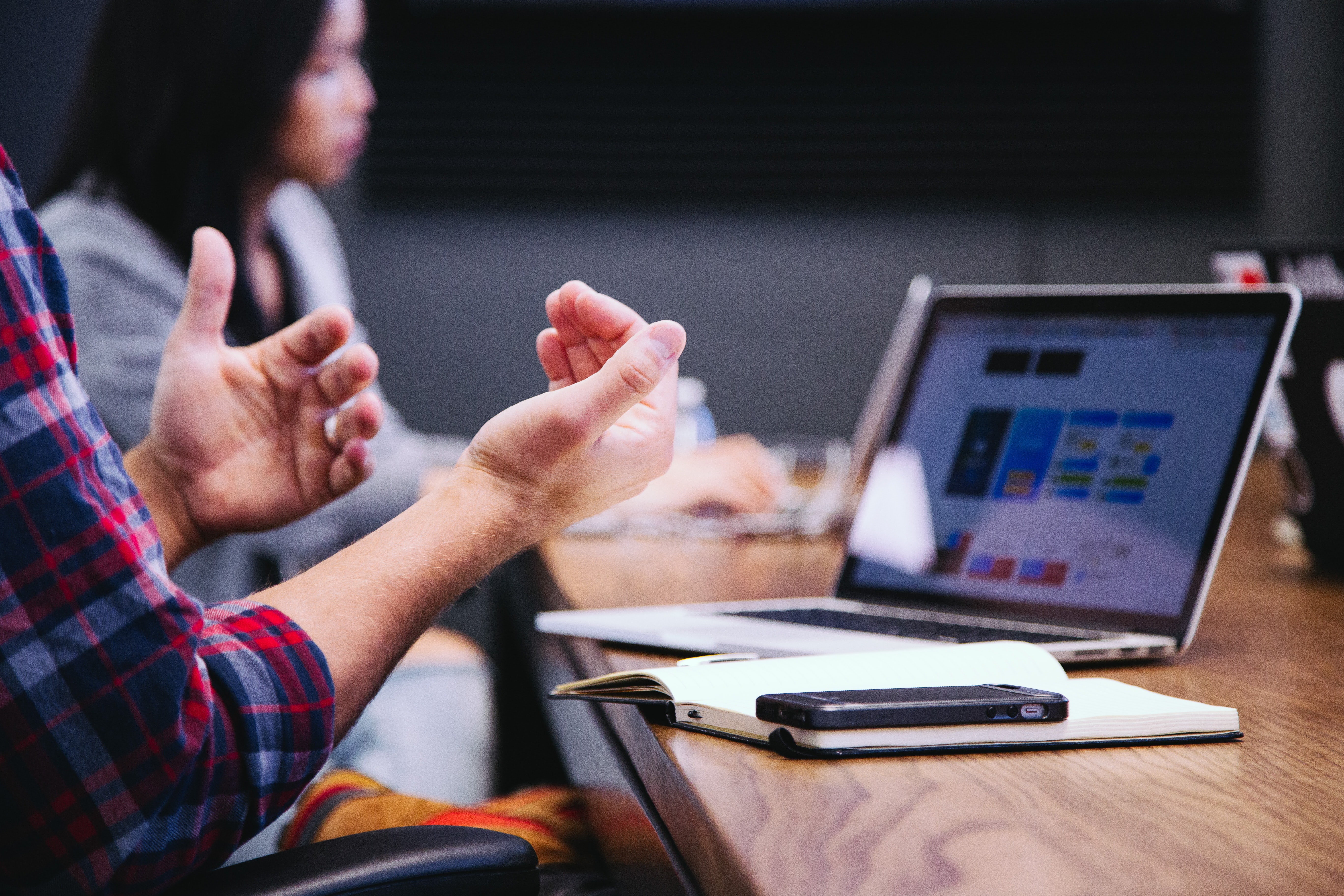 Remote workers discussing work in an office. Photo by @headway via Unsplash