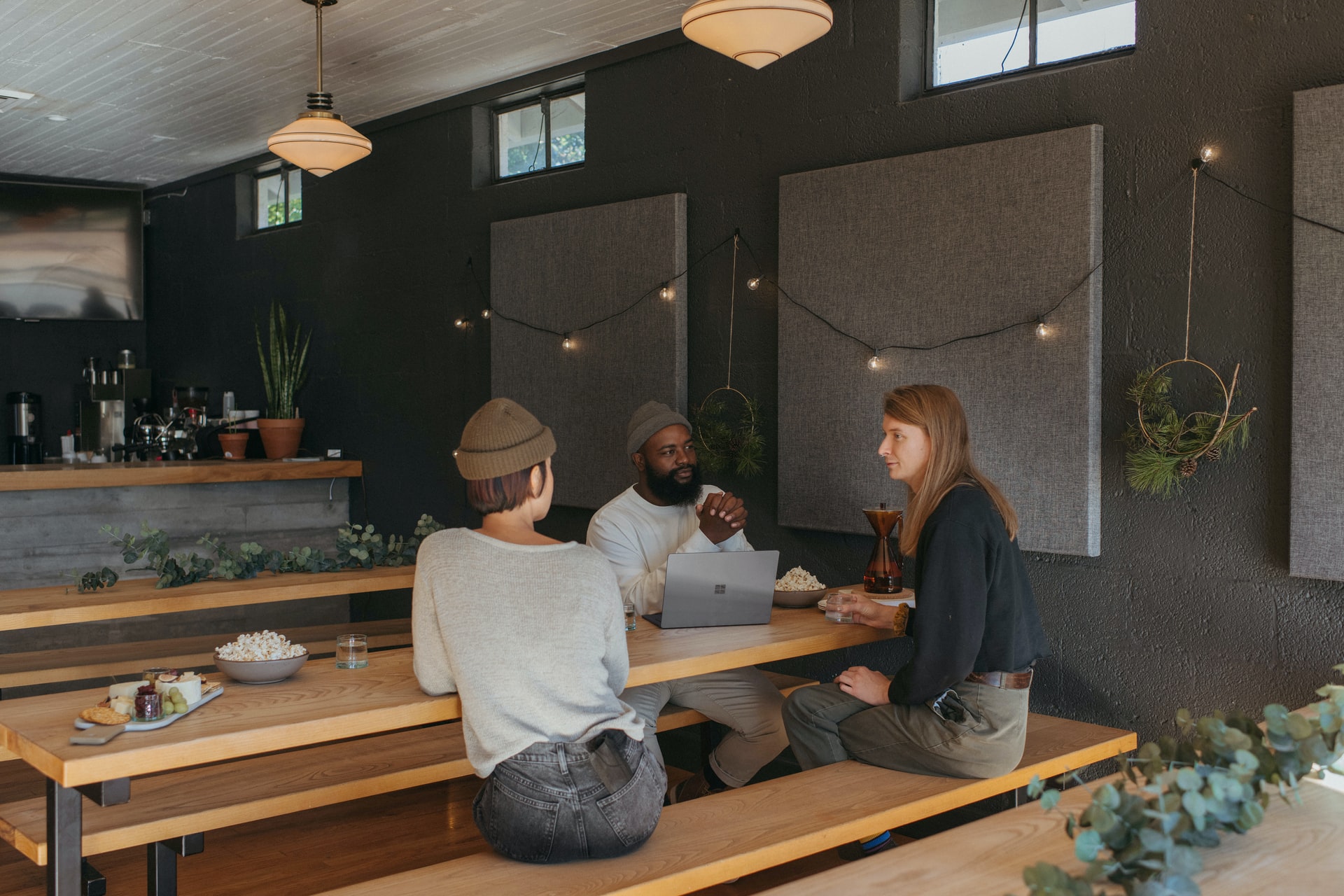 Coworking space colleagues chatting. Photo by @Surface via Unsplash